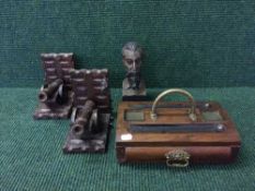 A pair of carved oak cannon bookends, carved bust of a man,