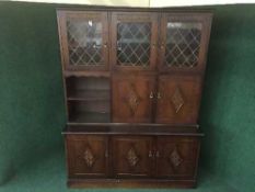 An oak leaded glass door display unit