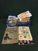 A basket of assorted stamp albums and loose stamps