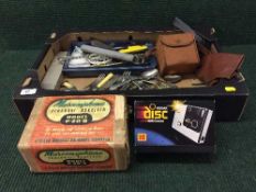 Two boxes containing Art Deco light shades, Wedgwood lidded pot, miscellaneous cutlery, cameras,