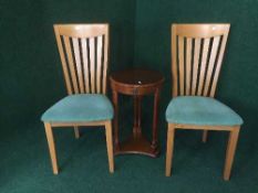 A circular inlaid mahogany two tier lamp table and pair of kitchen chairs