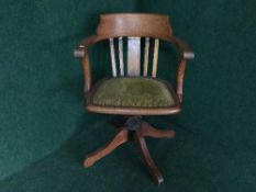 An Edwardian oak captain's style swivel armchair