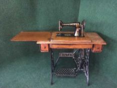 A Singer treadle sewing machine in oak table