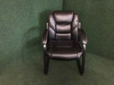 A black leather office armchair