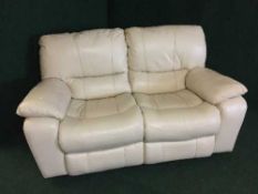 A cream leather two seater manual reclining settee