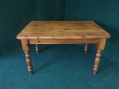 A stained pine kitchen table