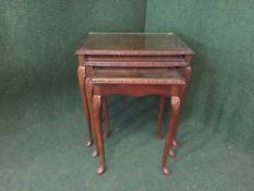 A nest of three mahogany tables on cabriole legs