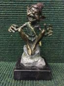 A bronze figure of a goblin by David Goode on marble plinth