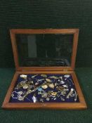A glazed oak table top jewellery cabinet containing a quantity of costume jewellery,