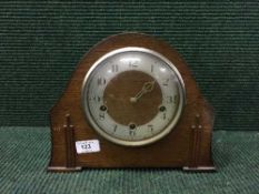 An oak cased mantel clock