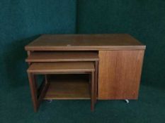 A mid 20th century teak TOT trolley table fitted with nest of two tables
