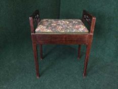 An Edwardian mahogany piano stool