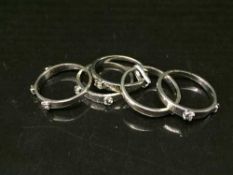 High carat white gold, tests 18, five-piece diamond ring with 9 stones approximately .6 carat, 8.