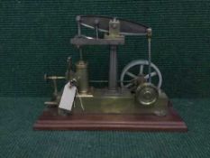 A scratch built brass live steam piston engine on plinth