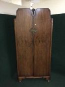 A walnut fitted gent's wardrobe