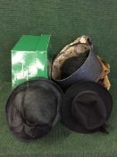 A box of assorted lady's hats, leather satchels,