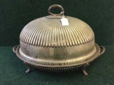 A large silver plated meat server with dome cover