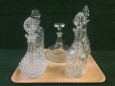 A tray of five assorted cut glass decanters and stoppers