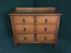 An Edwardian oak three drawer chest