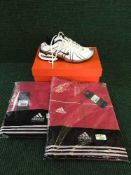 An Adidas two-piece tracksuit, red and white, size XL, brand new with tags,