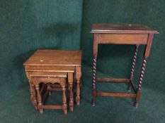 An oak occasional table and a nest of three oak tables