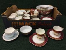 A box containing Aynsley and Stanley bone china tea sets, oriental dishes,