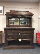 A carved oak marble topped sideboard with mirror back,