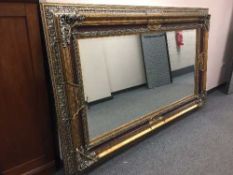 An impressive bevelled overmantle mirror in silvered and gilt frame 234 cm x 133 cm