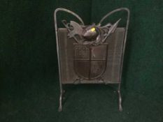 A early 20th century metal fire guard bearing coat of arms