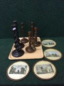 A tray of three pairs of wooden candlesticks and four hand coloured engravings