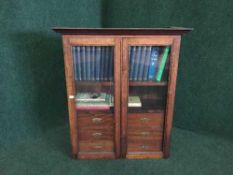 A 19th century glazed oak table top cabinet and contents (books etc)