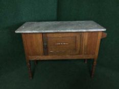 An Edwardian oak marble topped washstand