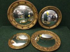 Three circular porthole mirrors and a gilt framed mirror