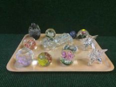 A tray of assorted glass paperweights and a glass motor car
