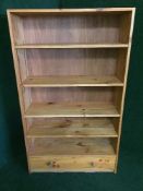 A set of pine open shelves fitted a drawer
