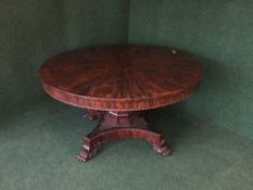 A William IV mahogany pedestal dining table on paw feet,
