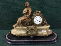 A Victorian gilt metal figural mantel clock on ebonised base