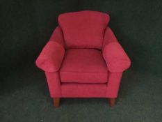 A contemporary Marks and Spencer armchair upholstered in red fabric