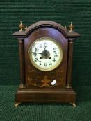 An Edwardian inlaid mahogany eight day bracket clock