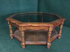An octagonal glass topped coffee table