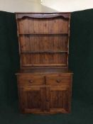 A stained pine kitchen dresser