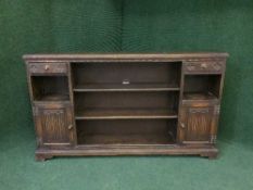 A set of carved oak bookshelves fitted cupboards