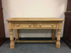 A Victorian style pine hall table fitted with two drawers,