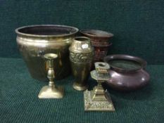 A tray of brass candlesticks, beaten copper bowl,