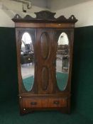 An Edwardian mahogany mirrored double door wardrobe