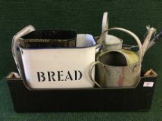 A box containing aluminium water cans, enamel bread bin,