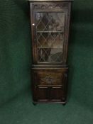 A Jaycee oak leaded glass door corner cupboard