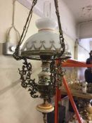 A decorative converted continental metal hanging oil lamp and pair of matching wall lights