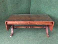 A Bevan and Funnel drop end coffee table with plate glass top