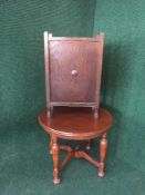 A circular stained oak occasional table and a stick stand